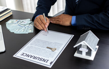 Young Asian businessman signed a document in the office.
