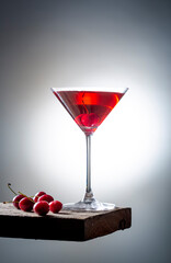 fresh red cherry juice in a wine glass with red cherries 