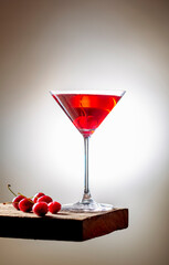 fresh red cherry juice in a wine glass with red cherries 