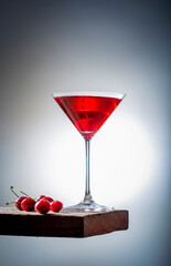 fresh red cherry juice in a wine glass with red cherries 