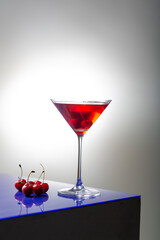 fresh red cherry juice in a wine glass with red cherries 