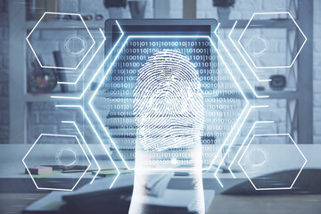 Computer on desktop in office with finger print drawing. Double exposure. Concept of business data security.