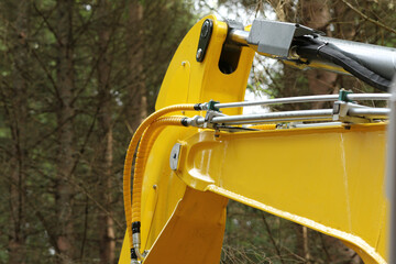 Crane arm of forest harvester with detail on hydraulic system.