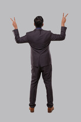 Businessman Very Happy and Excited, Raising arms, Celebrating a Victory or Success View from Back. Winner Sign, Peace Sign. Indian Business man Standing Full Lenght Isolated