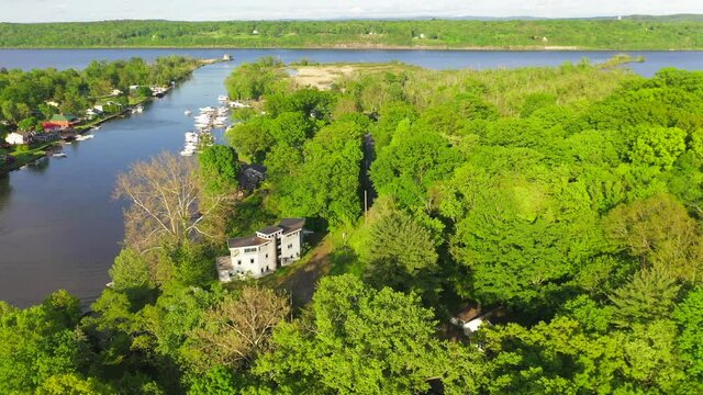 Aerial shot of an empty, waterfront mansion near Esopus Creek. 