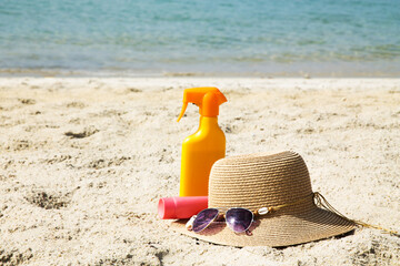 suntan cream and hat on the beach, summer vacation and relax concept