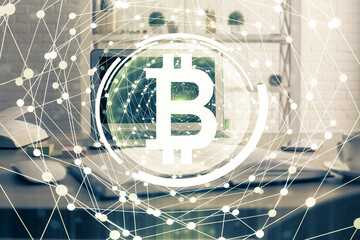 Multi exposure of blockchain theme hologram and table with computer background. Concept of bitcoin crypto currency.