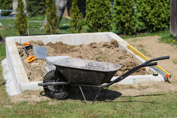 Preparation of foundations and internal sidewalk for the greenhouse.