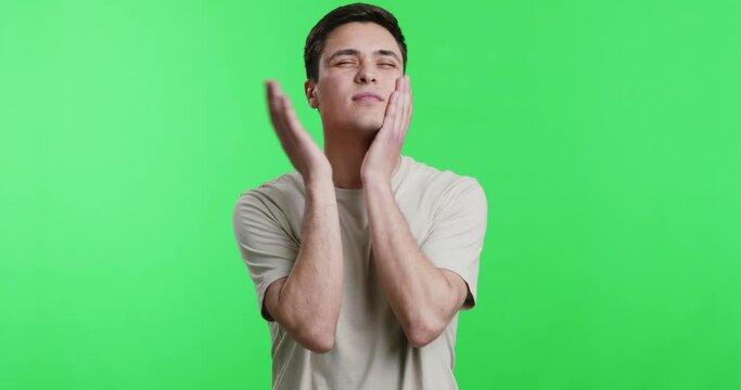 Young man slapping his cheeks, chroma key background
