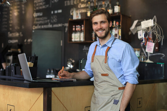 Small business owner working at his cafe.