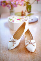Morning of the bride, white shoes lying on the floor