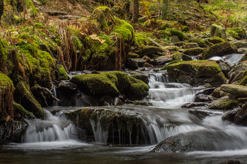 Fototapeta na wymiar little beautiful waterfall with moss and rocks