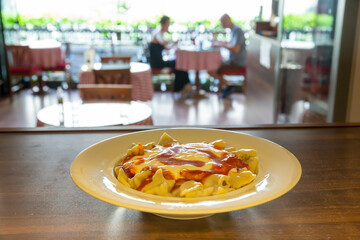 Ravioli - Turkish Manti on plate with red pepper. Selective focus