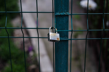 Padlock. The iron chain. Metal gate.