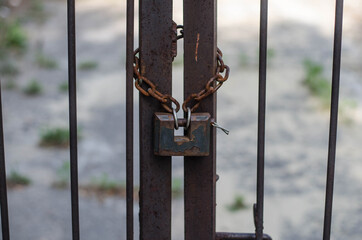 Padlock. The iron chain. Metal gate.