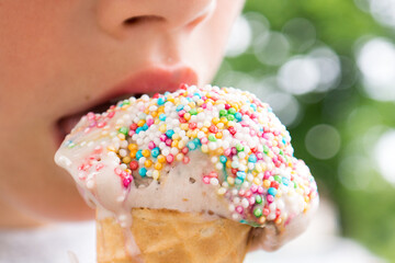 licking ice cream with colorful candy top