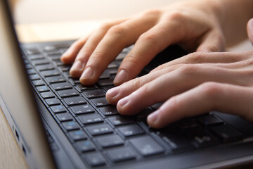 female hands typing on a keyboard