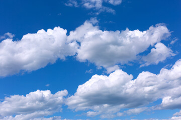 White clouds on blue sky background.
