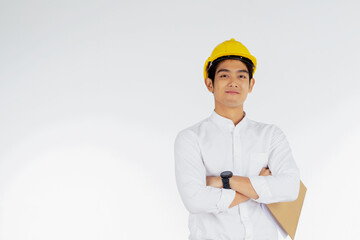 Portrait of handsome engineer wearing a yellow helmet at work and carrying a document on a white background