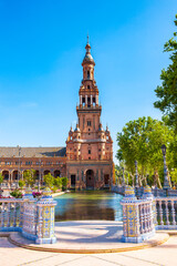 Fototapeta premium It's Tower and river of the Central building at the Plaza de Espana in Seville, Andalusia, Spain. It's example of the Renaissance Revival style in Spanish architecture.