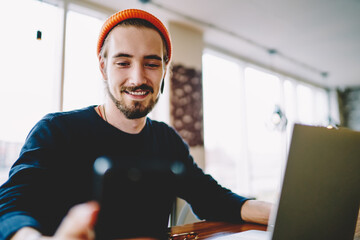 Successful blogger reading received message during social chatting with web followers using...