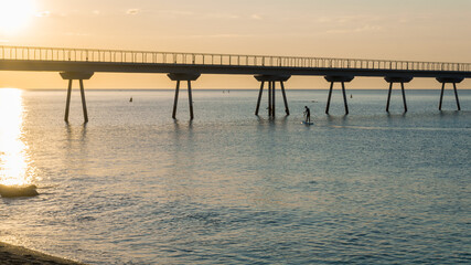 Fototapeta premium young boy doing paddle surf in the sea