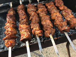 cooking meat on embers