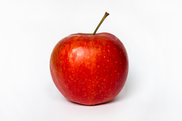 Bright juicy red apple on white studio background