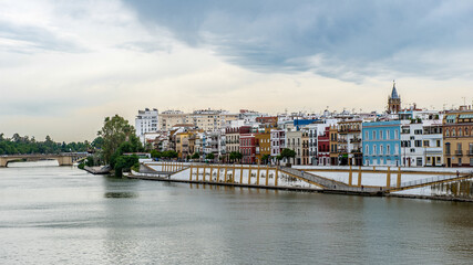 It's Guadalquivir river coast and architecture of Seville, Andalusia, Spain.