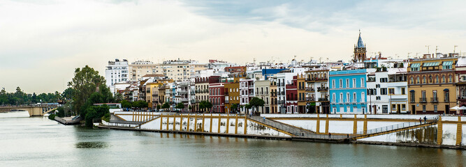 It's Guadalquivir river coast and architecture of Seville, Andalusia, Spain.