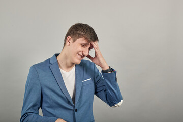 Holding head with hand can not believe shocked and despair being in panic, having forgetful look. Frustrated nervous freaking out, worrying because messed up. Young attractive man, dressed jacket