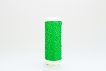 skein of green thread on a white background