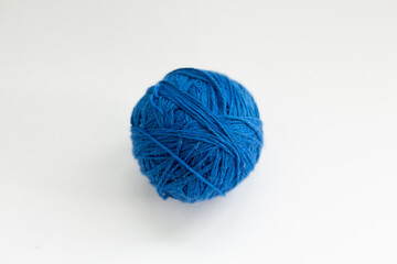 ball of blue thread on a white background