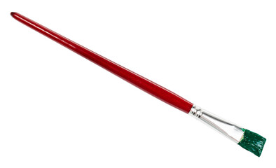 flat paint brush with green colored tip and brown handle isolated on white background