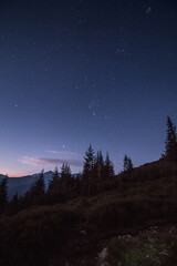 Fototapeta na wymiar Night sky full of stars just before sunrise in mountains