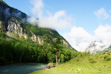 Fototapeta na wymiar landscape with a river and foggy sunny mountains