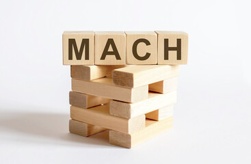 Text MACH on a wooden cube blocks on white background