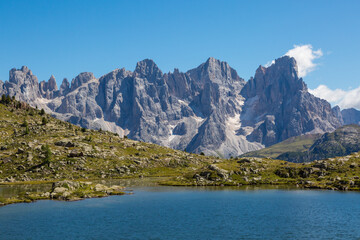 lake and pala group mountain summits pale di san Martino in blue sky