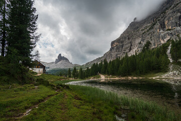 Mountain hut or shelter near lake in Dolomites. Italian landscape of Cortina D'Ampezzo region