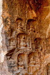 Fototapeta na wymiar It's Longmen Grottoes ( Dragon's Gate Grottoes) or Longmen Caves.UNESCO World Heritage of tens of thousands of statues of Buddha and his disciples