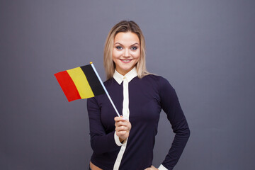 Immigration and the study of foreign languages, concept. A young smiling woman with a Belgium flag...