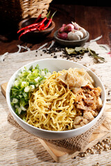 Mie ayam pangsit. Chicken dumpling noodles. Boiled noodles plus chicken, dumplings, mustard greens, sliced scallions.