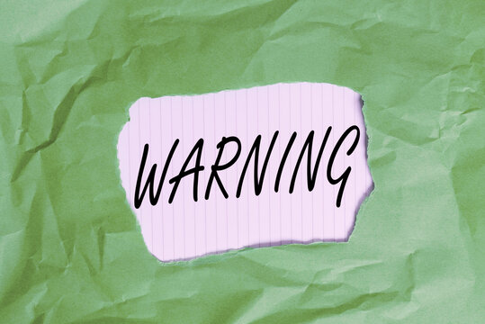 Writing note showing Warning. Business concept for statement or event that indicates a possible or impending danger Green crumpled colored paper sheet torn colorful background