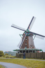 Fototapeta premium Windmills in Zaanse Schans village, near the sea coast, on a cloudy day.