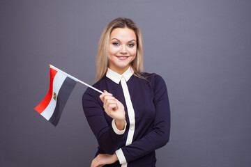 Immigration and the study of foreign languages, concept. A young smiling woman with a Egypt flag in...