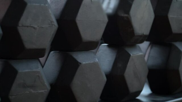 Black dumbbells are in the gym. High quality FullHD footage