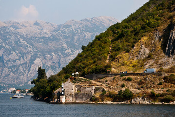 Fototapeta na wymiar View of the mountainous shore and the lighthouse in the Mediterranean