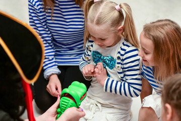 Children play a game with an animator in time to remove a finger