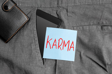 Conceptual hand writing showing Karma. Concept meaning sum of an individual actions in this and...