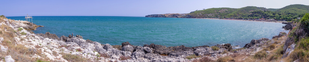 The most beautiful beaches of Apulia: San Nicola Bay,Peschici. It's surrounded by two rocks which dive in the sea, discloses a long stretch of golden and fine sand, perfect for pleasant strolls,Italy.
